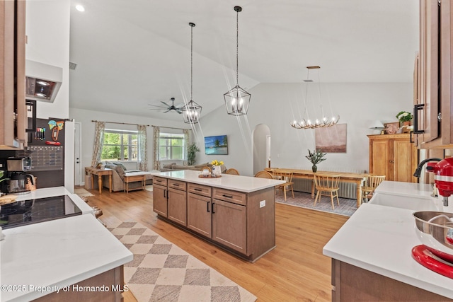 27295 Tarbel Rd, Brooksville, FL 34602 - kitchen with vaulted ceiling, a ceiling fan, light wood finished floors, open floor plan, and a sink