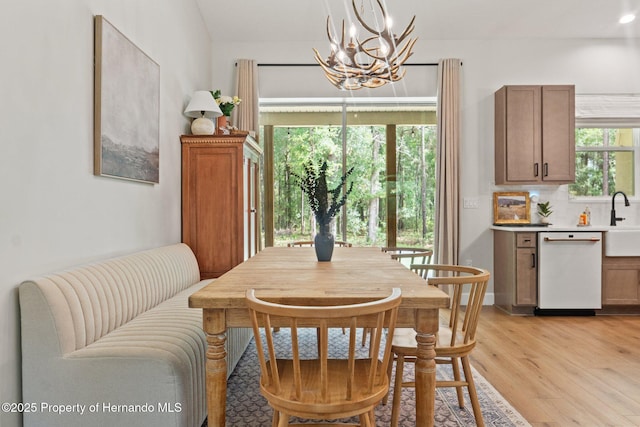 27295 Tarbel Rd, Brooksville, FL 34602 - dining room featuring a chandelier and light wood-style flooring