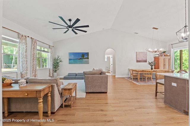 27295 Tarbel Rd, Brooksville, FL 34602 - living area featuring a chandelier, arched walkways, ceiling fan, lofted ceiling, and light wood-style flooring