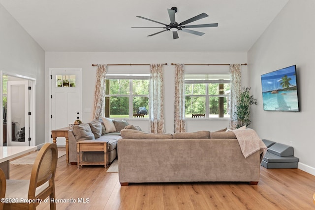 27295 Tarbel Rd, Brooksville, FL 34602 - living room featuring ceiling fan, light wood-style flooring, and baseboards