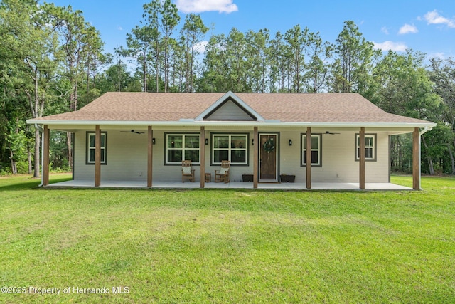 27295 Tarbel Rd, Brooksville, FL 34602 - view of front of property with a ceiling fan, a front lawn, and covered porch