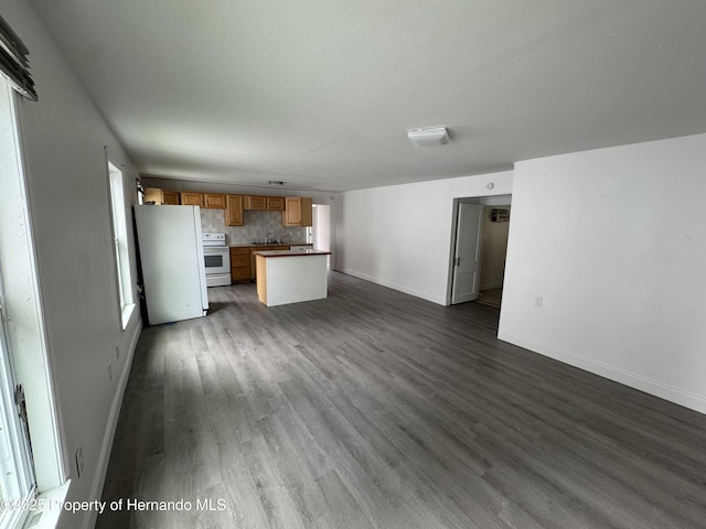 221 Highland St, Brooksville, FL 34601 - unfurnished living room with baseboards and dark wood-style floors