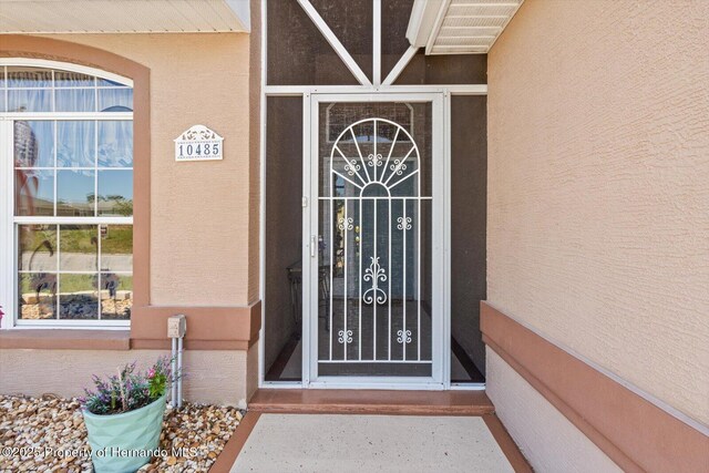 10485 S Drew Bryant Cir, Floral City, FL 34436 - view of exterior entry with stucco siding
