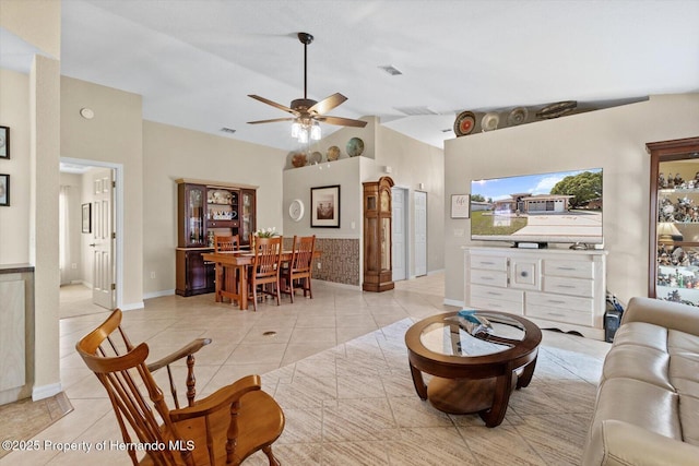 10485 S Drew Bryant Cir, Floral City, FL 34436 - living room with light tile patterned floors, ceiling fan, baseboards, and high vaulted ceiling