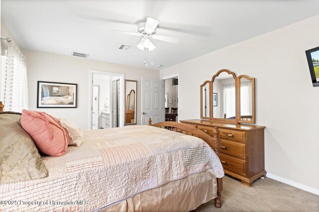 10485 S Drew Bryant Cir, Floral City, FL 34436 - carpeted bedroom with ensuite bath, baseboards, and a ceiling fan