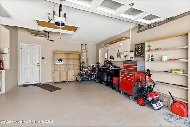 10485 S Drew Bryant Cir, Floral City, FL 34436 - garage featuring a garage door opener and a workshop area