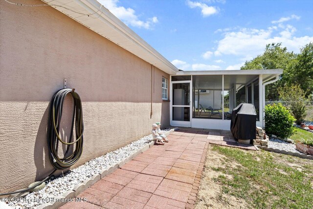 10485 S Drew Bryant Cir, Floral City, FL 34436 - view of patio with a sunroom and area for grilling