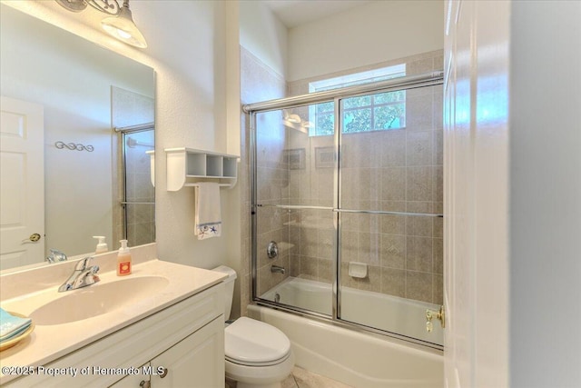 9406 Burnam Dr, Weeki Wachee, FL 34613 - bathroom featuring vanity, toilet, and shower / bath combination with glass door