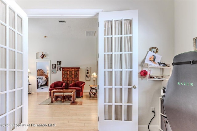 9406 Burnam Dr, Weeki Wachee, FL 34613 - living area with light wood-type flooring and french doors