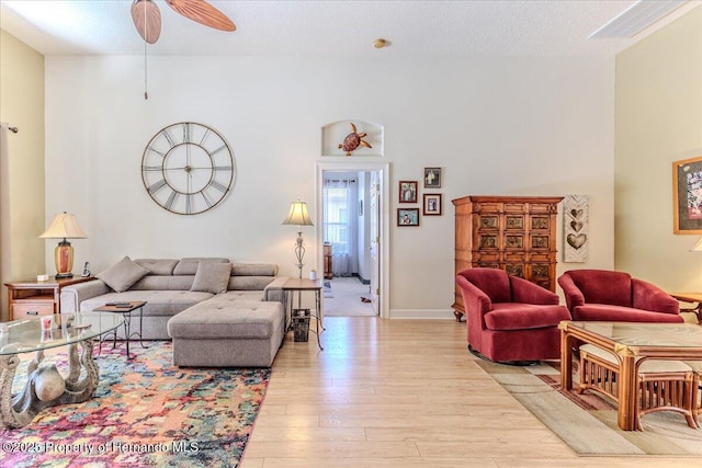 9406 Burnam Dr, Weeki Wachee, FL 34613 - living room featuring light wood finished floors, a ceiling fan, and baseboards