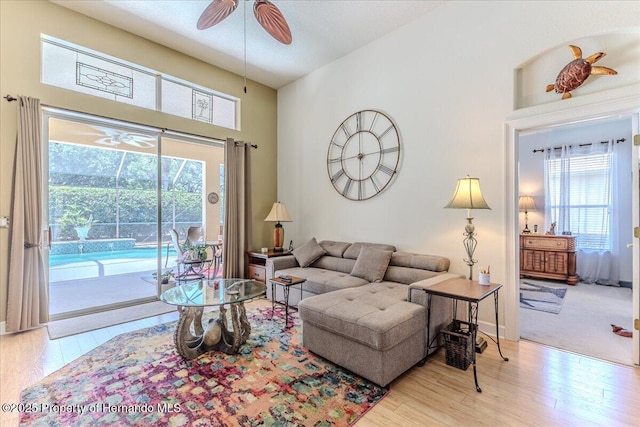 9406 Burnam Dr, Weeki Wachee, FL 34613 - living area with ceiling fan, wood finished floors, and a high ceiling