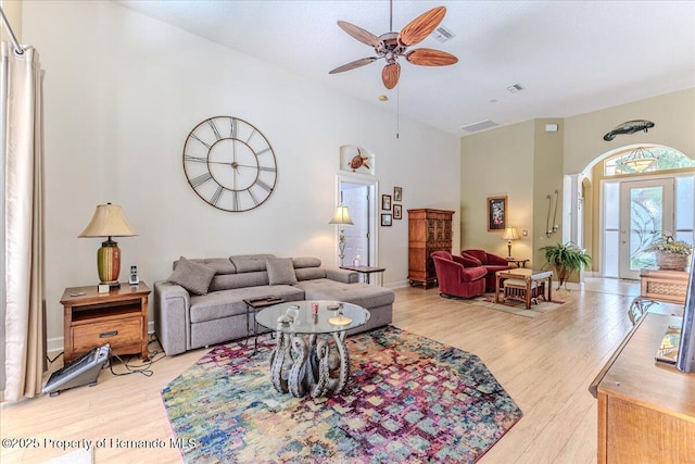 9406 Burnam Dr, Weeki Wachee, FL 34613 - living area featuring ceiling fan, a towering ceiling, and light wood-style flooring