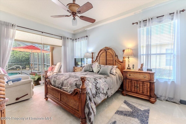 9406 Burnam Dr, Weeki Wachee, FL 34613 - carpeted bedroom featuring access to outside and a ceiling fan