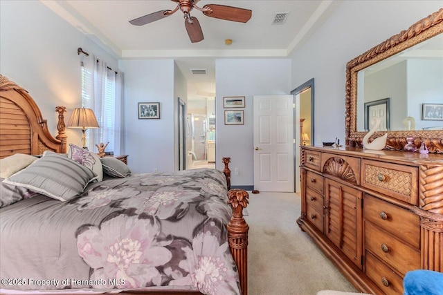 9406 Burnam Dr, Weeki Wachee, FL 34613 - bedroom featuring light carpet, a ceiling fan, and connected bathroom