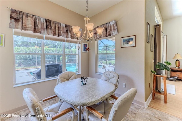 9406 Burnam Dr, Weeki Wachee, FL 34613 - dining area with a chandelier and baseboards
