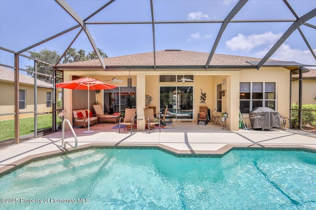 9406 Burnam Dr, Weeki Wachee, FL 34613 - outdoor pool with a patio area, a ceiling fan, and a lanai
