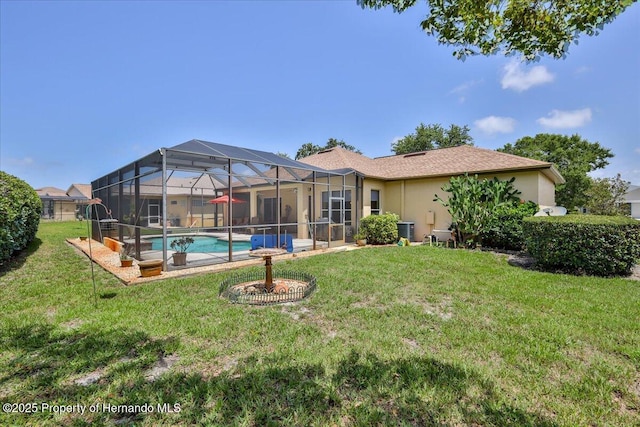 9406 Burnam Dr, Weeki Wachee, FL 34613 - back of house with central AC unit, stucco siding, a lawn, and an outdoor pool