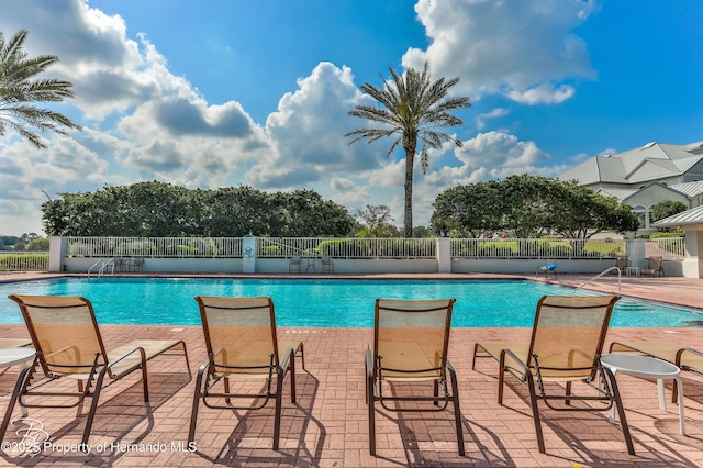 9406 Burnam Dr, Weeki Wachee, FL 34613 - community pool featuring a patio