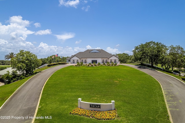 9406 Burnam Dr, Weeki Wachee, FL 34613 - french provincial home with a front yard and curved driveway
