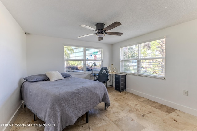 4566 Gulfstream Dr, Hernando Beach, FL 34607 - bedroom featuring baseboards, a textured ceiling, and a ceiling fan