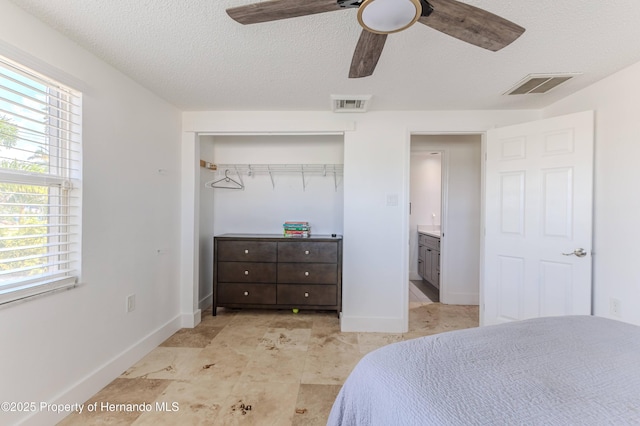 4566 Gulfstream Dr, Hernando Beach, FL 34607 - bedroom featuring a textured ceiling, a closet, baseboards, and a ceiling fan