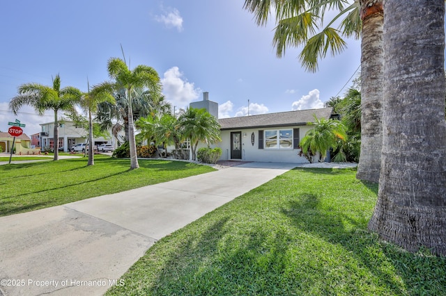 4566 Gulfstream Dr, Hernando Beach, FL 34607 - single story home with concrete driveway, a front yard, stucco siding, and a chimney