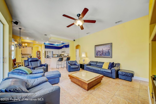 11422 Warm Wind Way, Weeki Wachee, FL 34613 - living room with arched walkways, ceiling fan, crown molding, a chandelier, and light tile patterned floors
