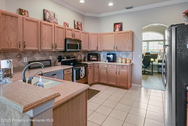 22316 Red Jacket, Land O Lakes, FL 34639 - kitchen with stainless steel appliances, light tile patterned floors, crown molding, arched walkways, and a sink
