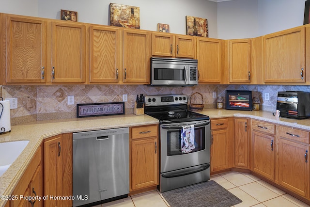 22316 Red Jacket, Land O Lakes, FL 34639 - kitchen featuring appliances with stainless steel finishes, light countertops, backsplash, and light tile patterned floors