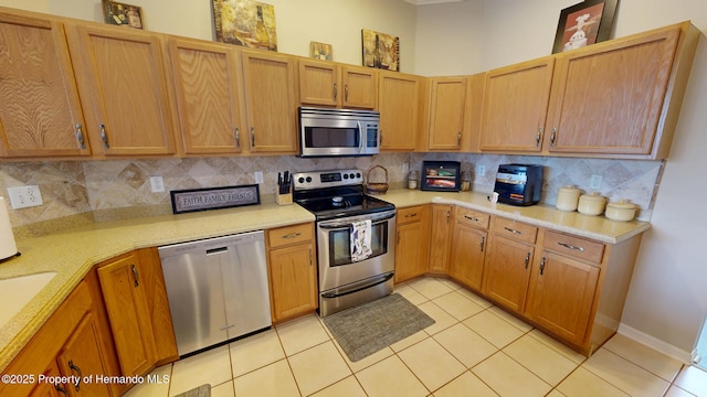 22316 Red Jacket, Land O Lakes, FL 34639 - kitchen with stainless steel appliances, light countertops, light tile patterned floors, and decorative backsplash