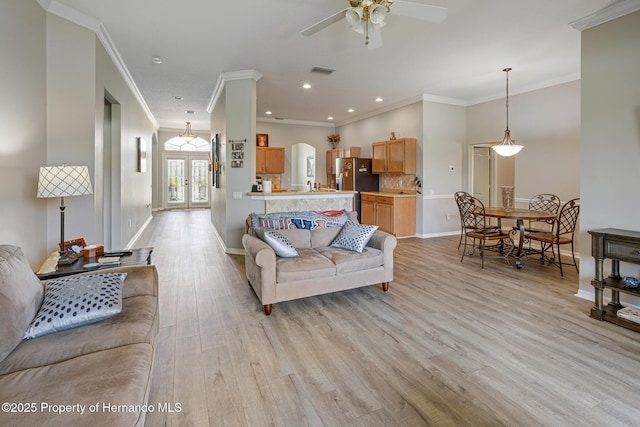 22316 Red Jacket, Land O Lakes, FL 34639 - living area with light wood-style floors, ceiling fan, crown molding, baseboards, and arched walkways