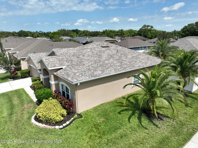 22316 Red Jacket, Land O Lakes, FL 34639 - view of side of home featuring stucco siding and a lawn