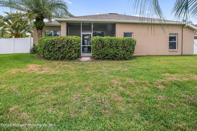 22316 Red Jacket, Land O Lakes, FL 34639 - rear view of house featuring stucco siding and a sunroom