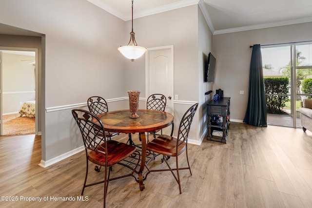 22316 Red Jacket, Land O Lakes, FL 34639 - dining room featuring light wood-type flooring, ornamental molding, and baseboards