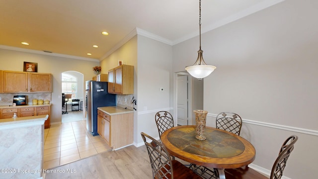 22316 Red Jacket, Land O Lakes, FL 34639 - dining space with arched walkways, ornamental molding, recessed lighting, light wood-type flooring, and baseboards