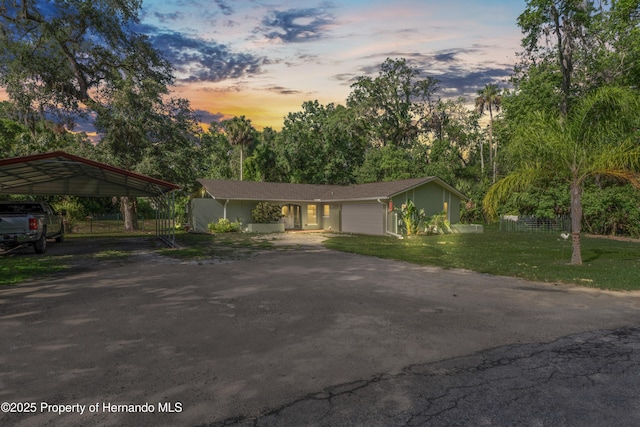 9766 W Smokey Ln, Crystal River, FL 34429 - view of front of house featuring driveway, a carport, and an attached garage