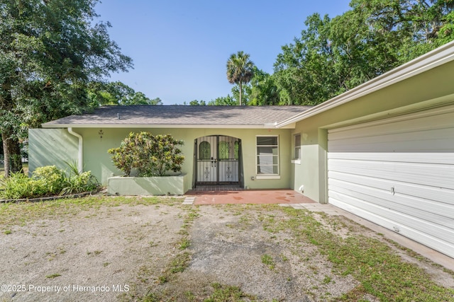 9766 W Smokey Ln, Crystal River, FL 34429 - view of front facade with a garage and stucco siding