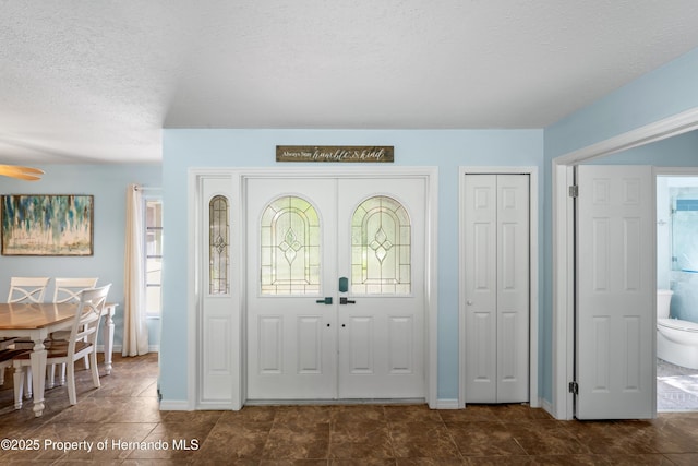 9766 W Smokey Ln, Crystal River, FL 34429 - foyer entrance with a textured ceiling, ceiling fan, and baseboards