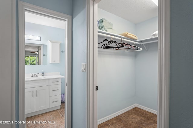 9766 W Smokey Ln, Crystal River, FL 34429 - walk in closet featuring a sink and light tile patterned floors