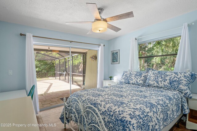 9766 W Smokey Ln, Crystal River, FL 34429 - bedroom with access to exterior, a textured ceiling, and a ceiling fan