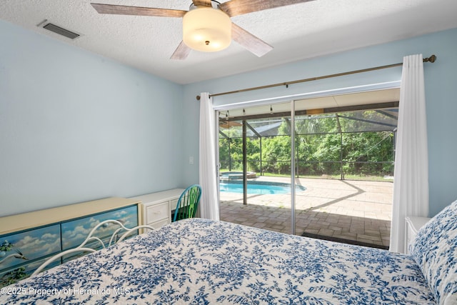 9766 W Smokey Ln, Crystal River, FL 34429 - bedroom featuring access to exterior, a textured ceiling, and a ceiling fan