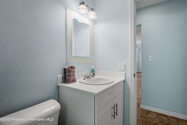 9766 W Smokey Ln, Crystal River, FL 34429 - half bath with vanity, toilet, and baseboards
