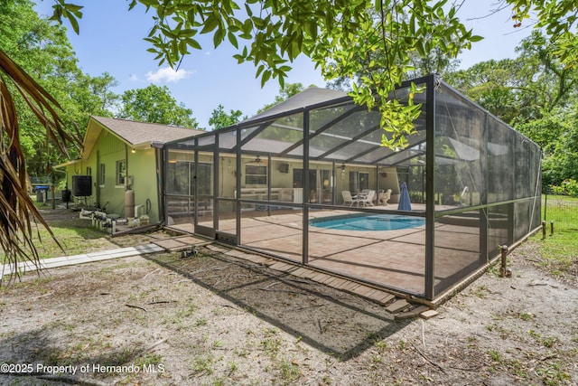 9766 W Smokey Ln, Crystal River, FL 34429 - outdoor pool with a patio and glass enclosure