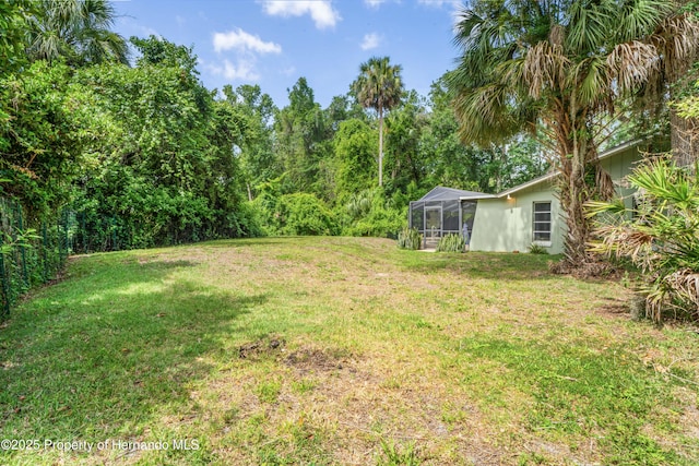 9766 W Smokey Ln, Crystal River, FL 34429 - view of green lawn with glass enclosure