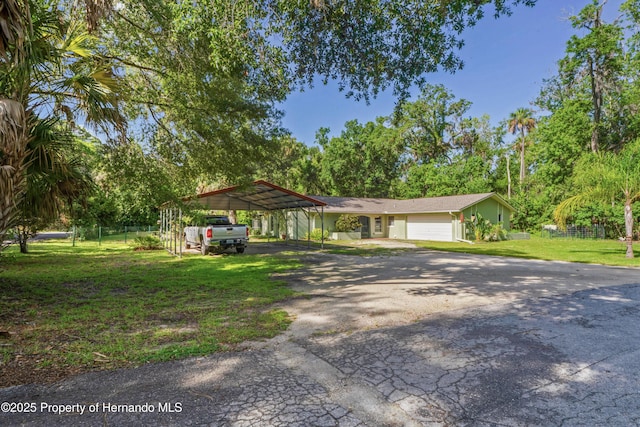 9766 W Smokey Ln, Crystal River, FL 34429 - view of front of home with asphalt driveway, a detached carport, and view of wooded area