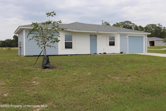2001 W Royal Palm Dr, Dunnellon, FL 34434 - ranch-style home featuring an attached garage, a front lawn, driveway, and roof with shingles