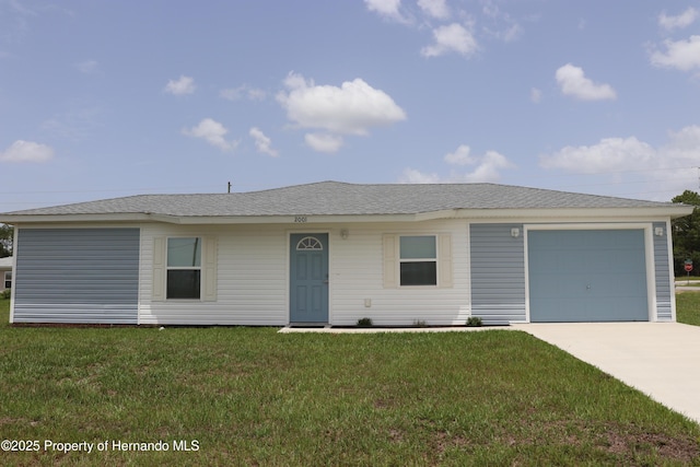 2001 W Royal Palm Dr, Dunnellon, FL 34434 - view of front of house with concrete driveway, a front lawn, and a garage