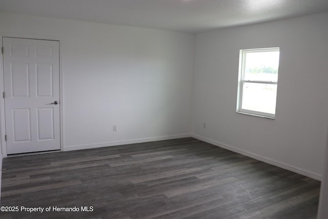2001 W Royal Palm Dr, Dunnellon, FL 34434 - spare room with dark wood-style floors and baseboards
