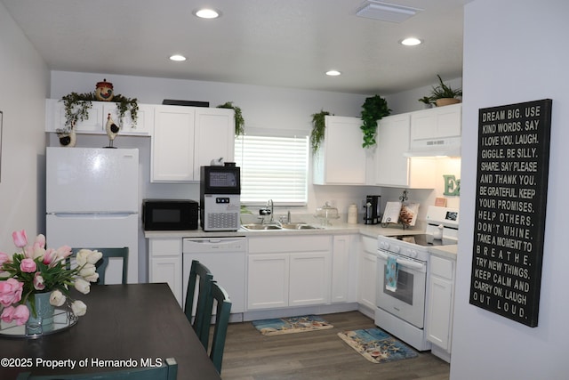 2001 W Royal Palm Dr, Dunnellon, FL 34434 - kitchen featuring white appliances, a sink, under cabinet range hood, white cabinetry, and dark wood-style flooring