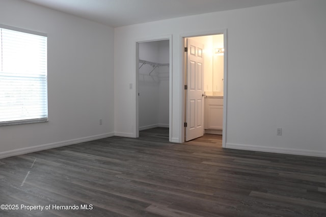 2001 W Royal Palm Dr, Dunnellon, FL 34434 - unfurnished bedroom with dark wood-style flooring, baseboards, and a closet